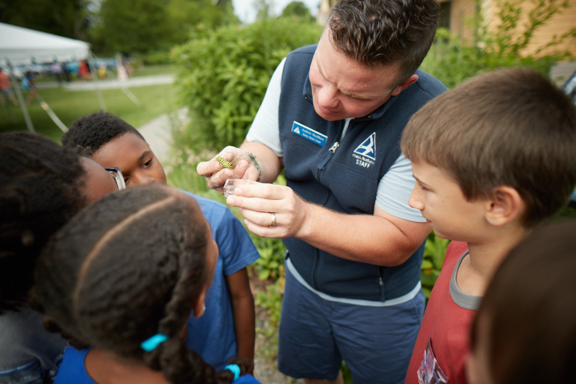 Mass Audubon staff showing children a caterpillar